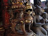 Kathmandu Patan Golden Temple 30 Statue Of Snow Lion Close Up And Two Kneeling Figures Outside Entrance Door To The Swayambhu Chaitya 